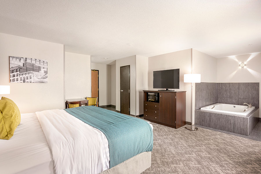 guest room with one king bed and jetted tub